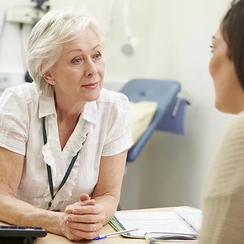 Specialist nurse supporting a patient during a consultation